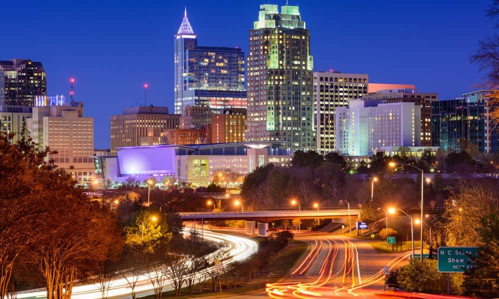 Raleigh city skyline with busy roads and traffic light trails