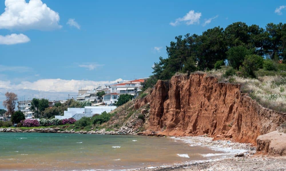 Aerial view of seaside homes near a steep eroding cliff showing how shifting coastlines can affect a flood elevation certificate
