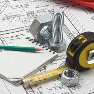 Close-up of engineering plans with measuring tools and notes used to prepare an accurate grading plan