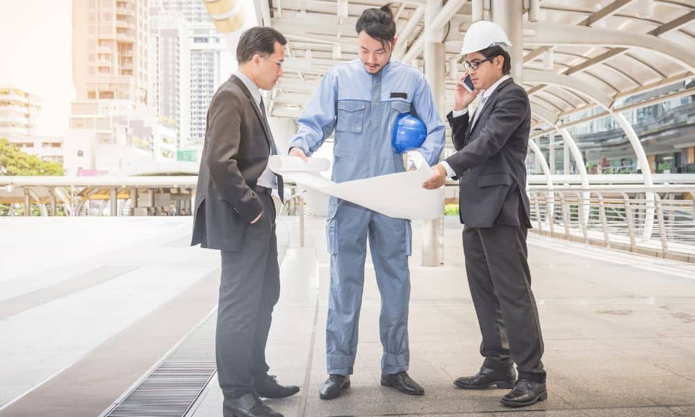 Project team reviewing blueprints on site - ALTA SURVEY North Carolina Project team reviewing blueprints on site as part of construction project management work