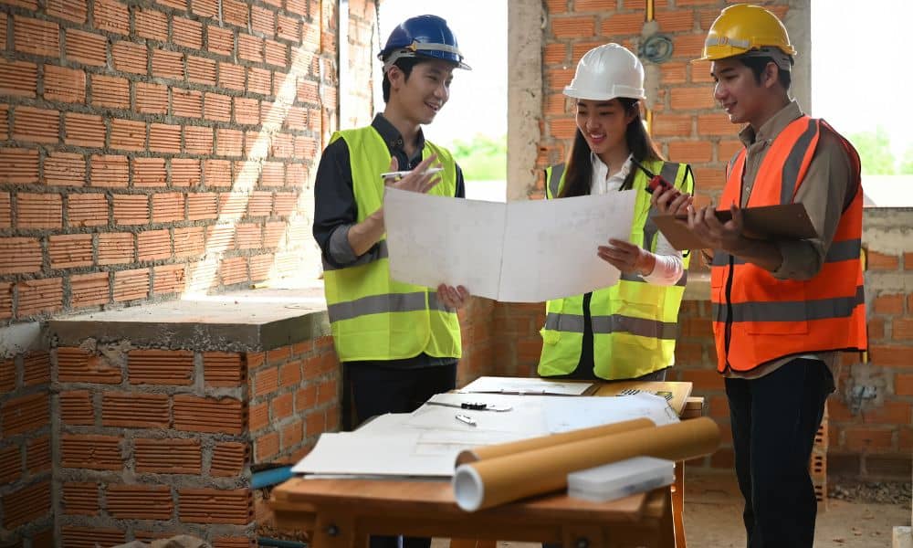 Structural engineer reviewing renovation plans on an active construction site