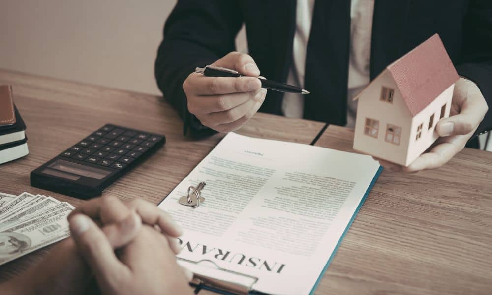 Real estate professionals reviewing documents and property details while discussing an ALTA survey during a transaction
