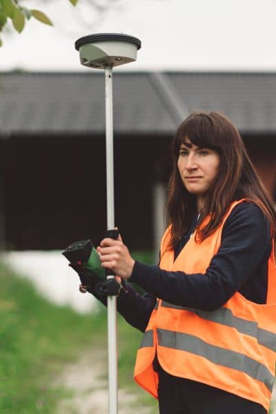 Subdivision planning with a GPS land surveyor checking property boundaries before splitting land