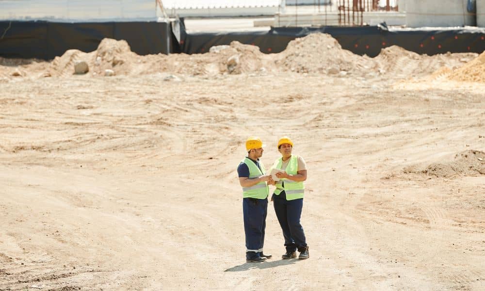 Land development engineer reviewing site conditions to assess project risk before purchase