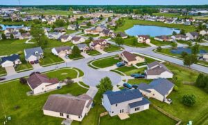 Aerial view of a new residential subdivision with grading, drainage, and detention pond showing stormwater design in action