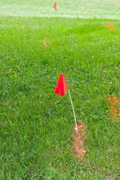 Survey flags marking property lines on a grassy site