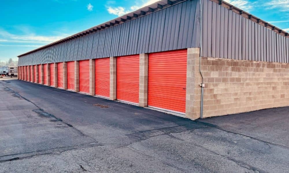 ALTA Survey Self Storage Facility Transaction - ALTA SURVEY North Carolina Self-storage building with red roll-up doors and a paved drive aisle, showing features documented in an ALTA survey for a facility transaction